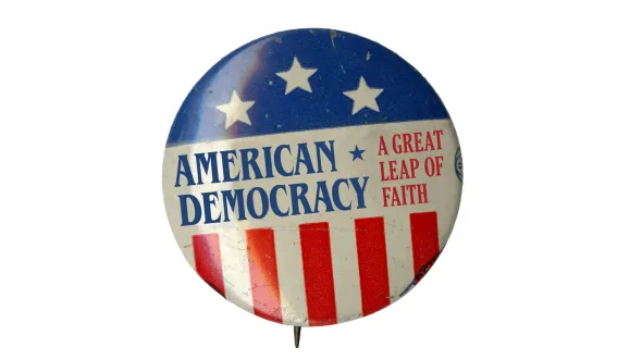 A color photograph of a button with the words, "American Democracy"