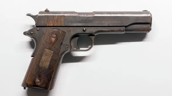 Colt, M1911 .45 caliber pistol with magazine. 