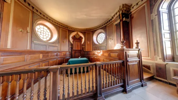An interior view of a historic wood-paneled court room