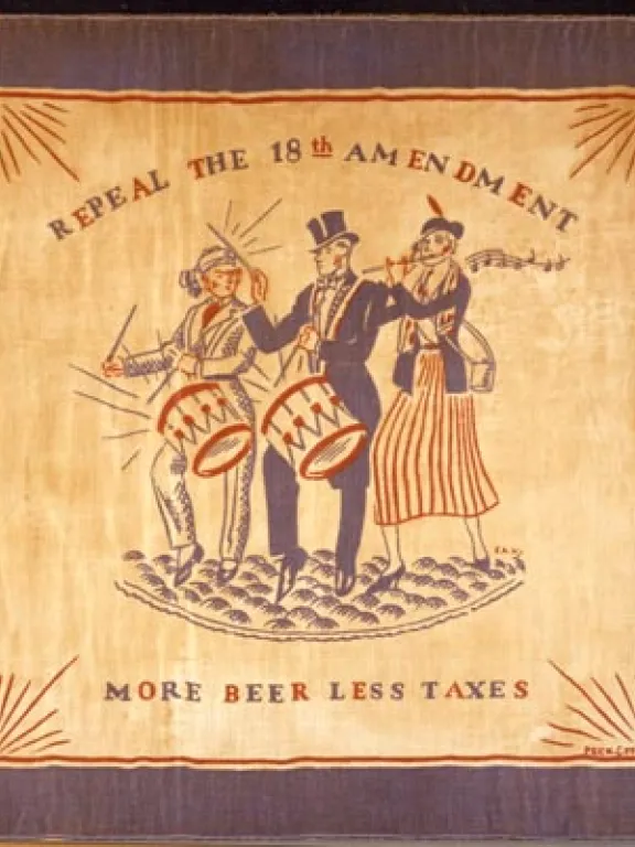 A square scarf with a blue border and an illustration of three people in the center, two of whom play handheld drums and 1 of whom plays a flute. Words read "Repeal the 18th Amendment: More Beer Less Taxes"