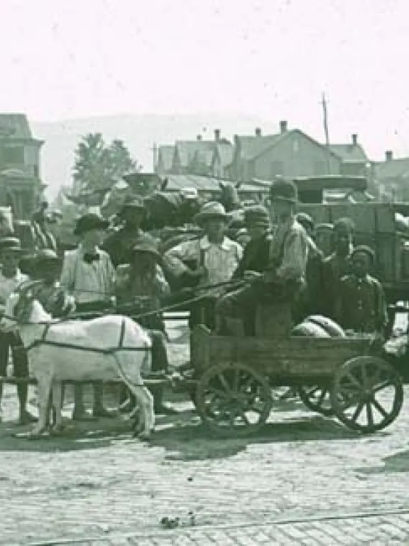 Street scene, goat cart and children.