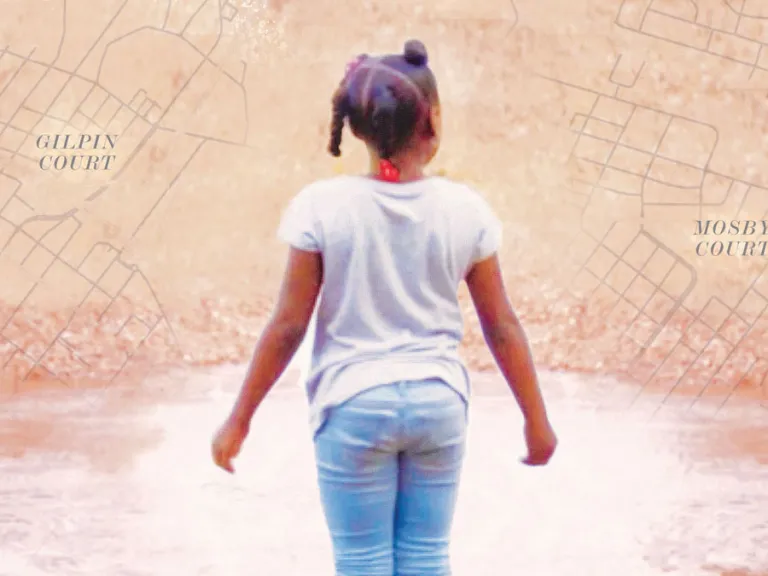 A young girl looks forward with a map in the background