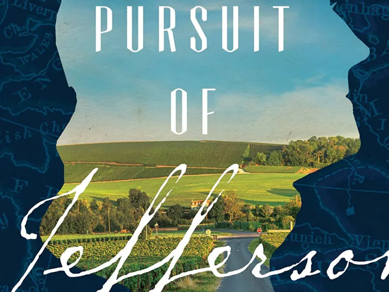 A blue background with silhouette cutaway in the shape of Jefferson's profile, with a hilly landscape showing through and words Pursuit of Jefferson