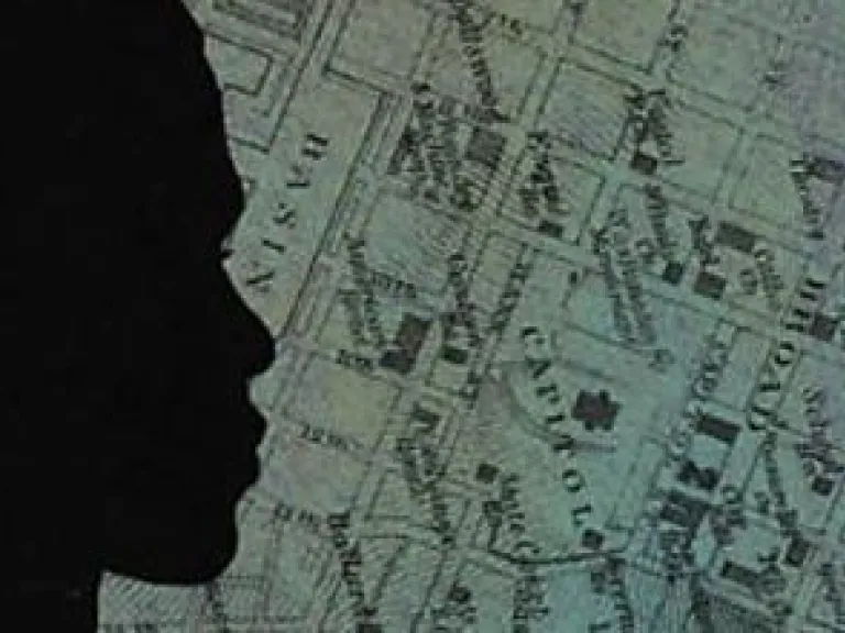A woman's silhouette in front of a street map