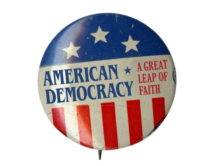 A color photograph of a button with the words, "American Democracy"