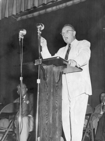 Harry Flood Byrd, Sr. Standing At a Podium Speaking Towards a Crowd. 