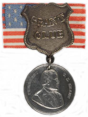 An American flag lapel ribbon and silver medal with a portrait of Ulysses S. Grant