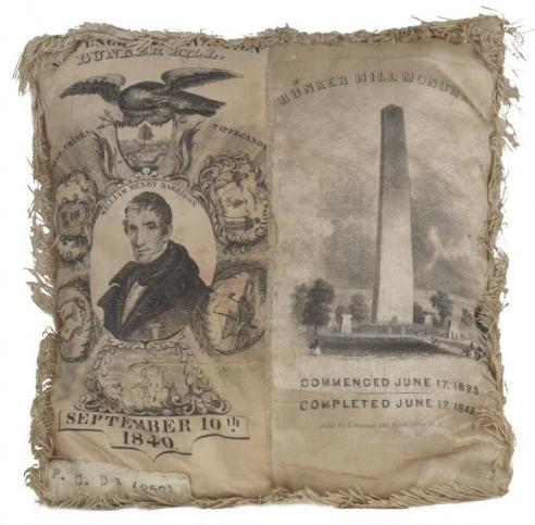 A sewing pillow with an image of William Henry Harrison and the Bunker Hill Monument. 
