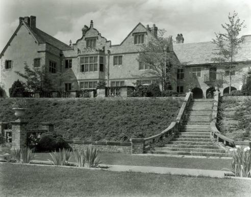 A vintage black and white photograph showing the back of Virginia House, a staircase, and back garden